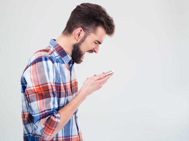 Young man shouting on smartphone